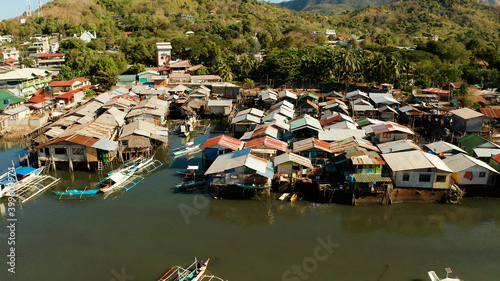 Coron city with slums and poor district. Old wooden house standing on the sea in the fishing village. Houses of local poor people.Busuanga, Coron, Philippines. houses community standing in water in