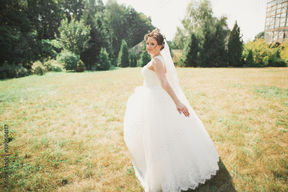 Beautiful bride spinning with perfect dress in the park Beautiful bride spinning with perfect dress in the park