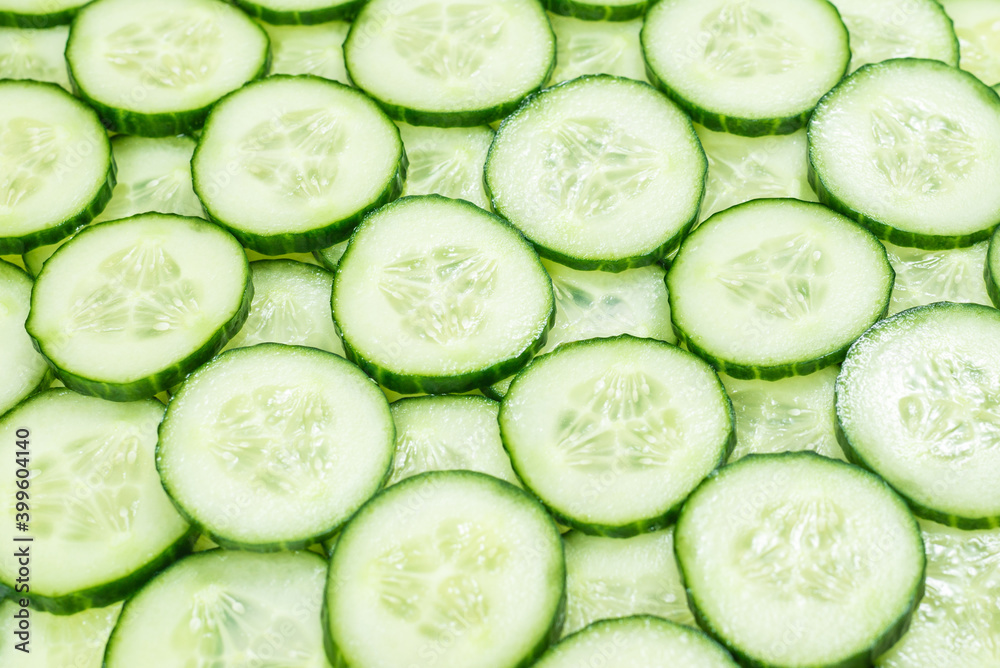 Fresh green slices of cucumber as background. Fresh green slices of cucumber as background.