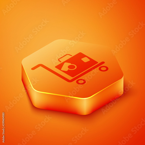 Isometric Hotel luggage cart with suitcase icon isolated on orange background. Traveling baggage sign. Travel luggage icon. Orange hexagon button. Vector.