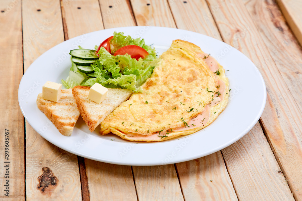 omelet with fresh vegetables and toasts