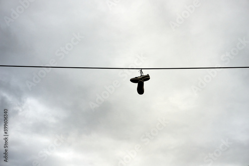 Shoes hanging on a wire outside