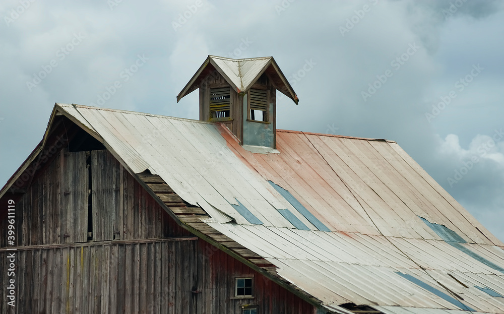 Barn roof top under stormy skies Barn roof top under stormy skies
