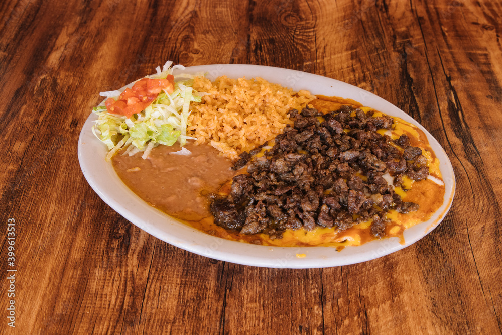 Mexican food enchiladas topped with beef and cheese Mexican food enchiladas topped with beef and cheese