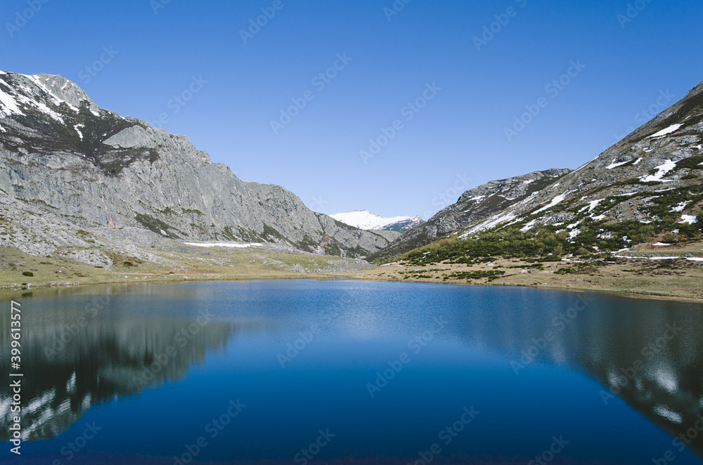Lake Isoba, Leon. Spain. Mountain landscape with lake and snowy mountains.