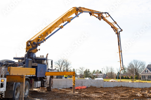 Large construction receiving concrete for foundation through a concrete mixer work