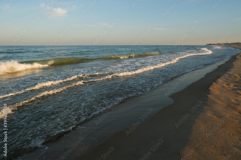 Sea beach with blue sky and yellow sand and some clouds