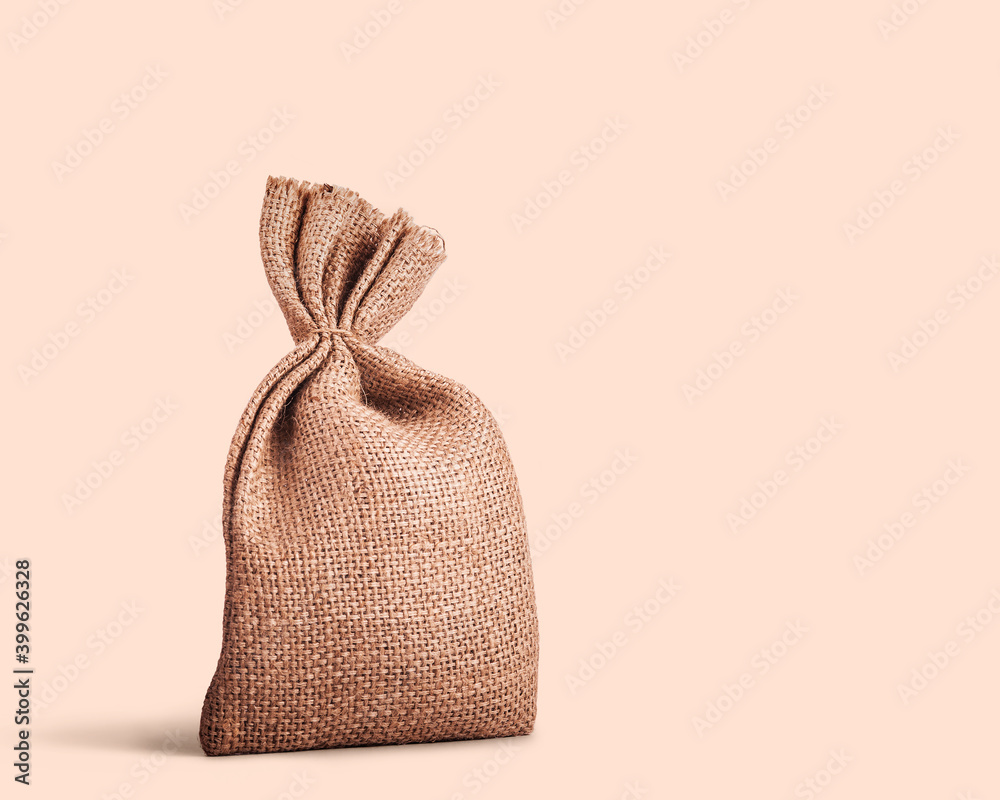 Jute coffee bag isolated on the ligh brown background Jute coffee bag isolated on the ligh brown background