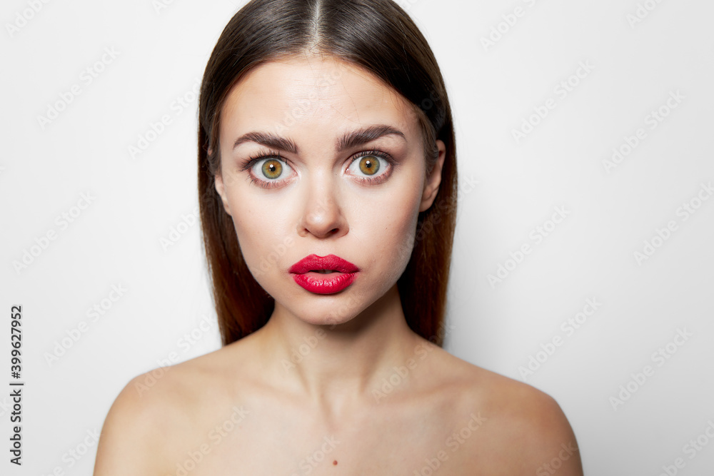 Woman with surprised facial expression red lips bared shoulders cropped Woman with surprised facial expression red lips bared shoulders cropped