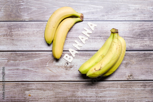 Banana wooden word with yellow banana fruit surrounding it