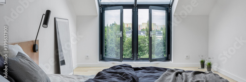 Attic bedroom with big window, panorama