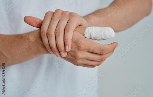 bandaged thumb health problems medicine isolated background © SHOTPRIME STUDIO