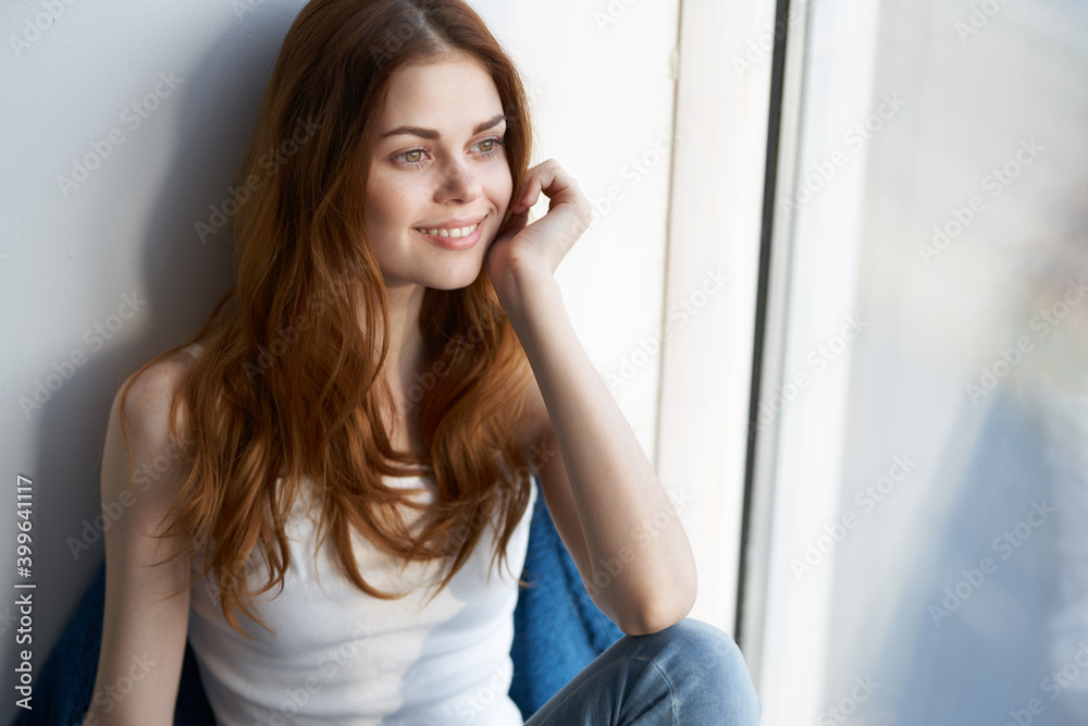 woman sitting on the windowsill near the window smile lifestyle interior