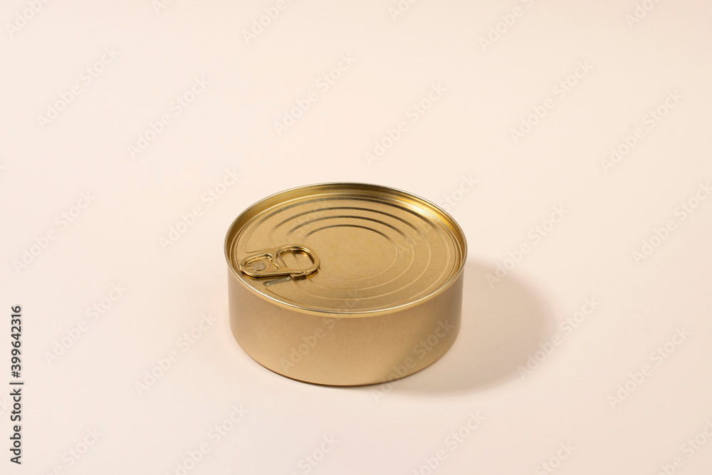 Gold unlabeled tin can on light background Gold unlabeled tin can on light background