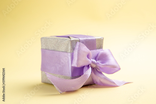 front view little present on a light-yellow background new year holiday xmas gift color photo