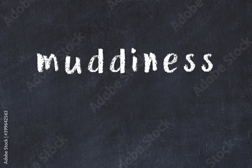 College chalk desk with the word muddiness written on in photo