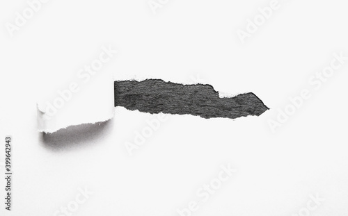 A piece of paper torn off revealing the contents. The concept of discovering content, supplementing with content. photo