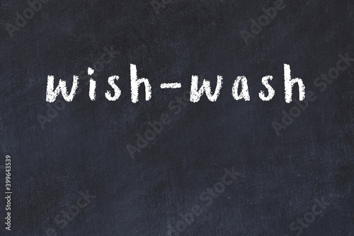 College chalk desk with the word wish-wash written on in photo