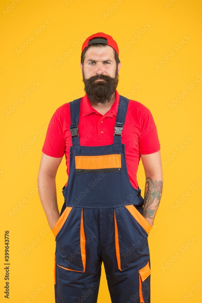 brutal bearded man in uniform. guy worker in coveralls and cap. male worker builder or engineer. mature mechanic service. skilled plumber. repairman after finishing work brutal bearded man in uniform. guy worker in coveralls and cap. male worker builder or engineer. mature mechanic service. skilled plumber. repairman after finishing work