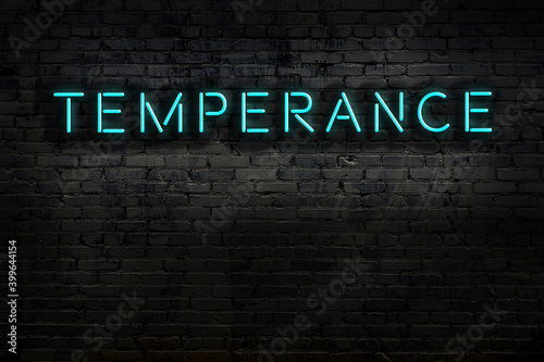 Night view of neon sign on brick wall with inscription temperance photo