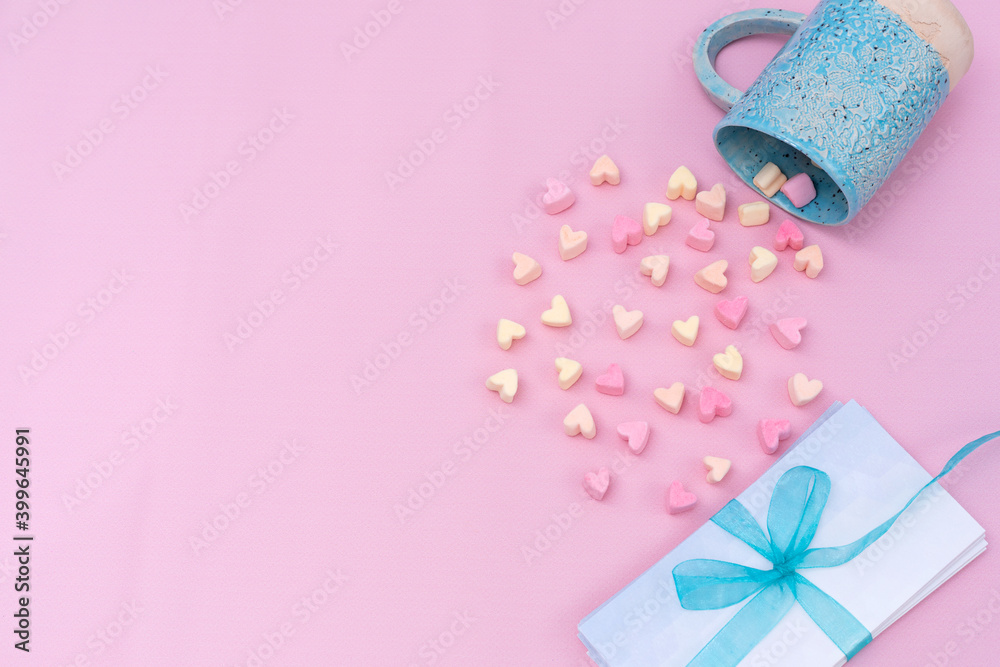 heartshaped marshmallow and envelopes with blue ribbon