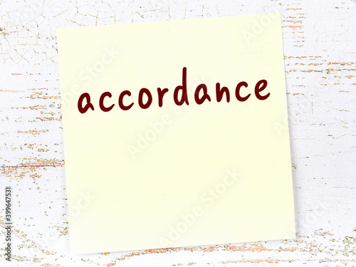 Fotografie Yellow sheet of paper with word accordance. Reminder concept