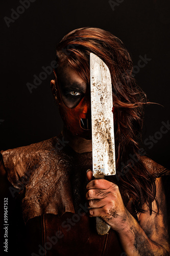 Portrait of a murderous savage armed with a knife that she holds in front of half of her face