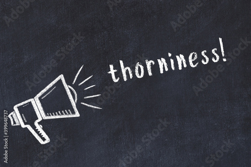 Chalk loudspeaker and inscription thorniness on black chalkboard