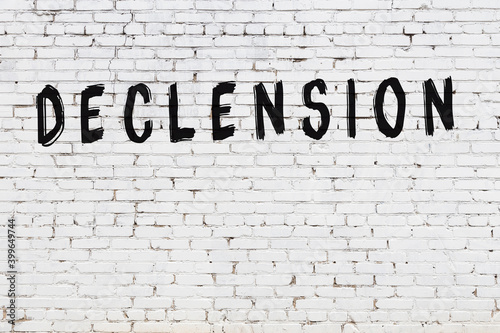 Inscription declension painted on white brick wall
