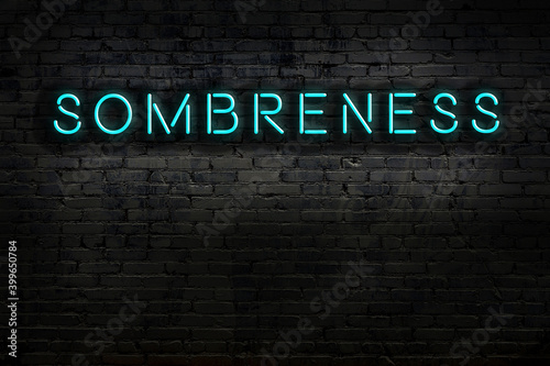 Neon sign. Word sombreness against brick wall. Night view