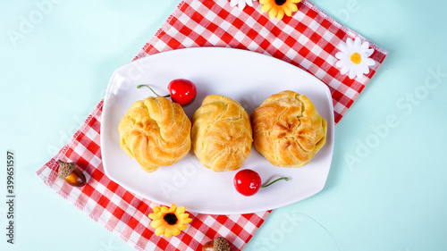 Indonesian cake, kue sus displayed with white plate and napkin