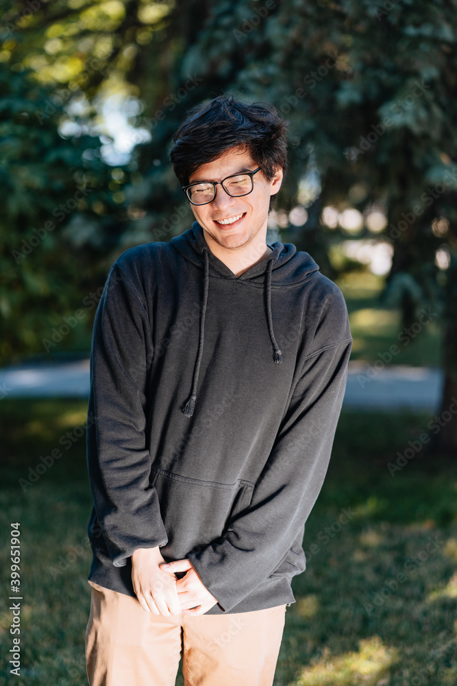 Portrait of happy young male student with glasses in casual outfit Portrait of happy young male student with glasses in casual outfit