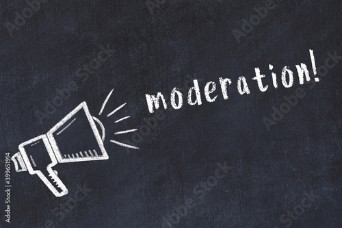 Chalk loudspeaker and inscription moderation on black chalkboard
