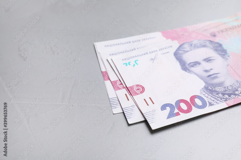 Ukrainian money on grey background, closeup. Space for text Ukrainian money on grey background, closeup. Space for text