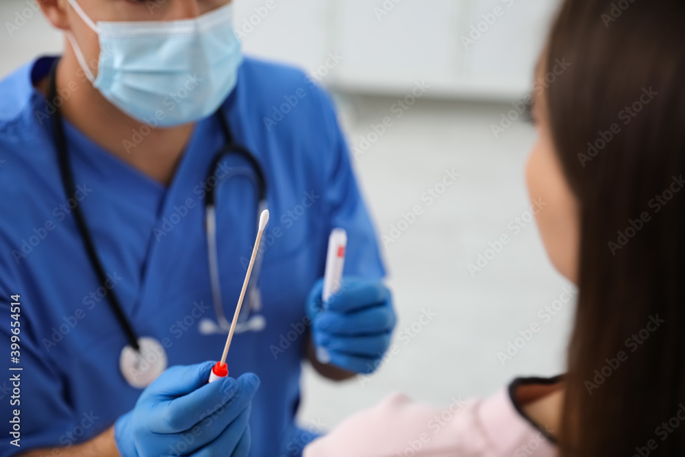 Doctor taking sample for DNA test from woman in clinic Doctor taking sample for DNA test from woman in clinic