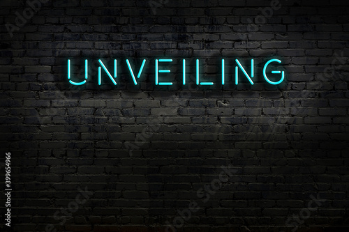 Fotografie Neon sign. Word unveiling against brick wall. Night view