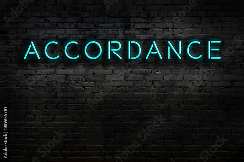 Valokuva Night view of neon sign on brick wall with inscription accordance
