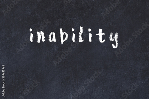 College chalk desk with the word inability written on in