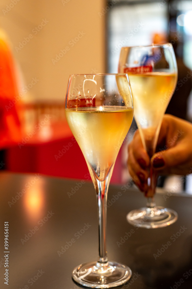 Tasting of cold brut Champagne sparkling wine  in underground cellars of wine house in Reims, Champagne, France