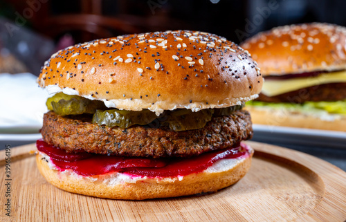 Lunch or dinner with tasty vegetarian hamburgers made from plant based grilled burgers, fresh bakes buns and organic vegetables