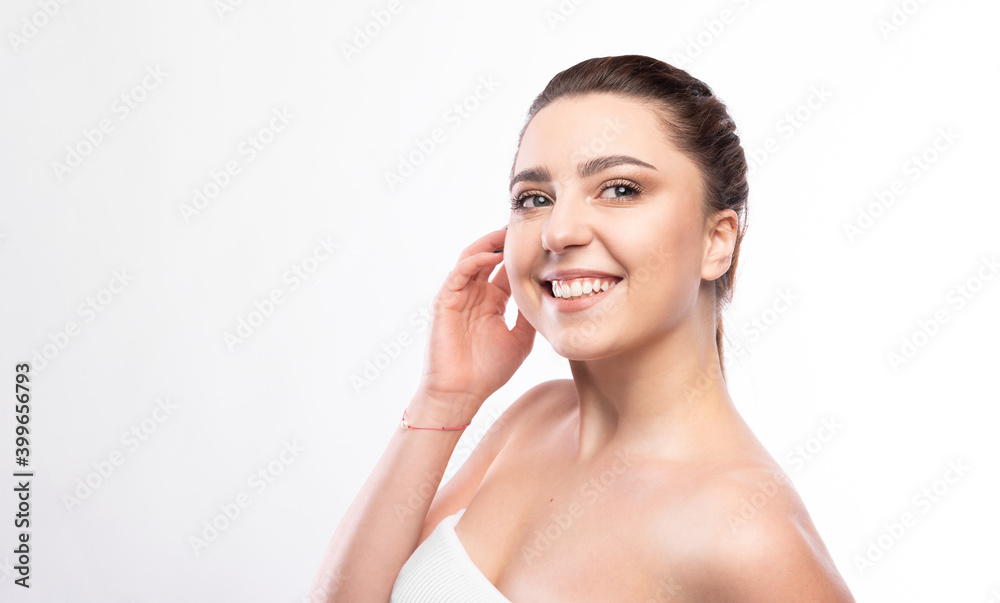 Happy beautiful girl holding her cheeks with a laugh looking to the side. Pretty woman clean fresh skin . Expressive facial expressions .Cosmetology , beauty and Spa Happy beautiful girl holding her cheeks with a laugh looking to the side. Pretty woman clean fresh skin . Expressive facial expressions .Cosmetology , beauty and Spa