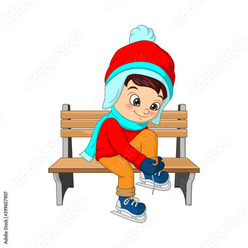 Cute boy in winter clothes sitting on a bench, little boy tying his shoelaces
