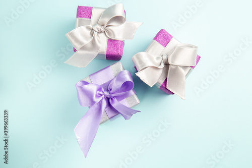 top view cute little presents tied with bow on blue background color photo gift new year xmas