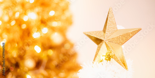 The gold cluster metallic star ornament hanging decorated on the Christmas tree and for the Celebrate with the Christmas season.