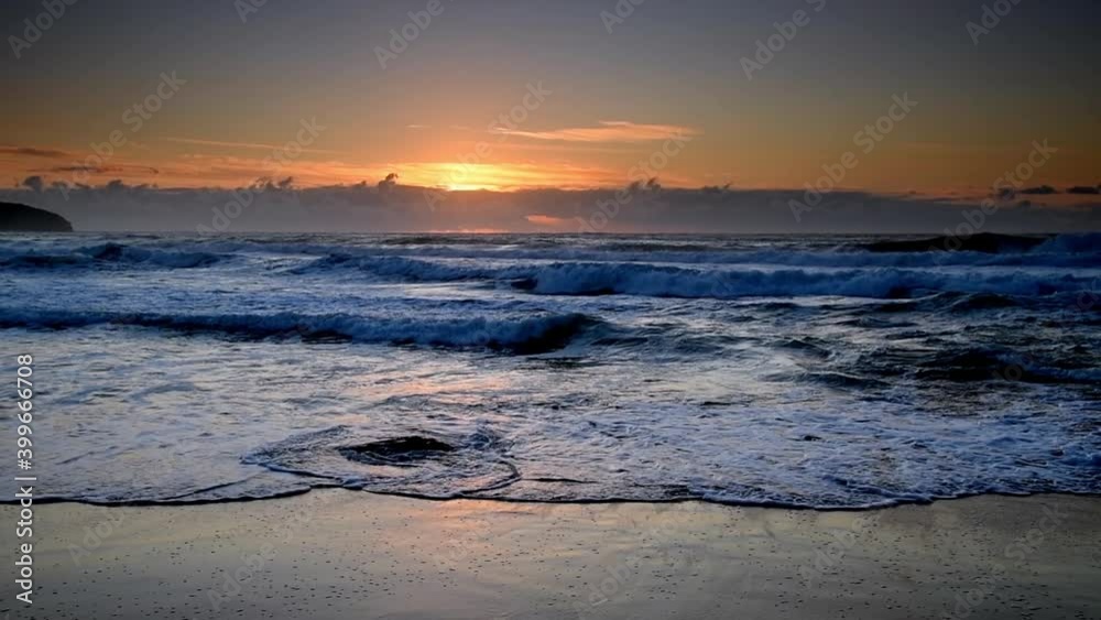 Sunrise seascape with light cloud and waves at Killcare Beach on the Central Coast of NSW, Australia. Sunrise seascape with light cloud and waves at Killcare Beach on the Central Coast of NSW, Australia.
