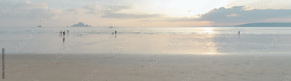 View of clean seashore with white sand and beautiful sky at sunset time.