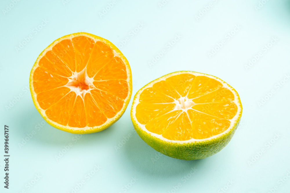 Fototapeta premium front view fresh tangerine slices on light-blue background fruit orange photo color citrus grapefruit