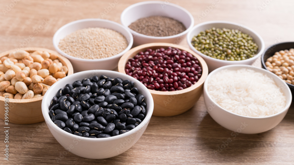 Various cereal grain in a bowl on wooden background (quinoa seeds, black kidney bean, peanut, perilla seeds, soybean, azuki beans, rice grain and mung beans) Various cereal grain in a bowl on wooden background (quinoa seeds, black kidney bean, peanut, perilla seeds, soybean, azuki beans, rice grain and mung beans)