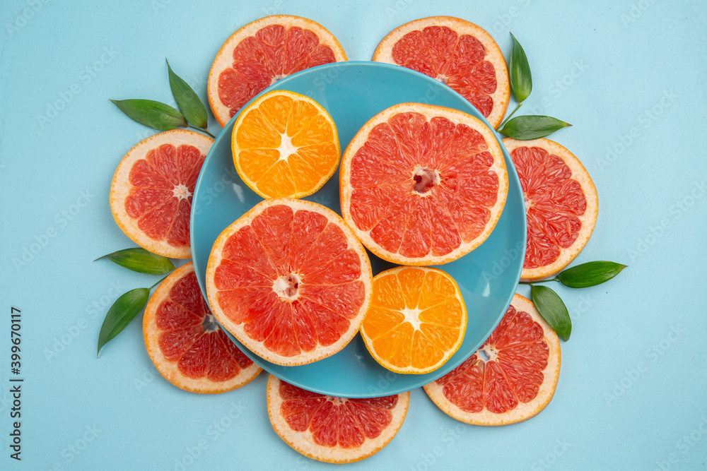 top view tasty grapefruits fruit slices on blue background fresh citrus fruits juice mellow color top view tasty grapefruits fruit slices on blue background fresh citrus fruits juice mellow color