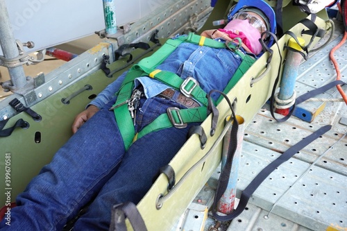 Injured workers encapsulate by sked stretcher to take off scaffolding in working at heights and transfer them to the field medical team as part of emergency drills at a chemical plant oil and gas. photo